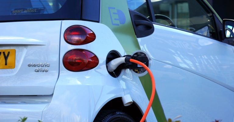 Close-up of an electric car being charged, highlighting eco-friendly transportation.
