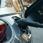 Close-up of an electric vehicle being charged, highlighting modern clean energy technology.